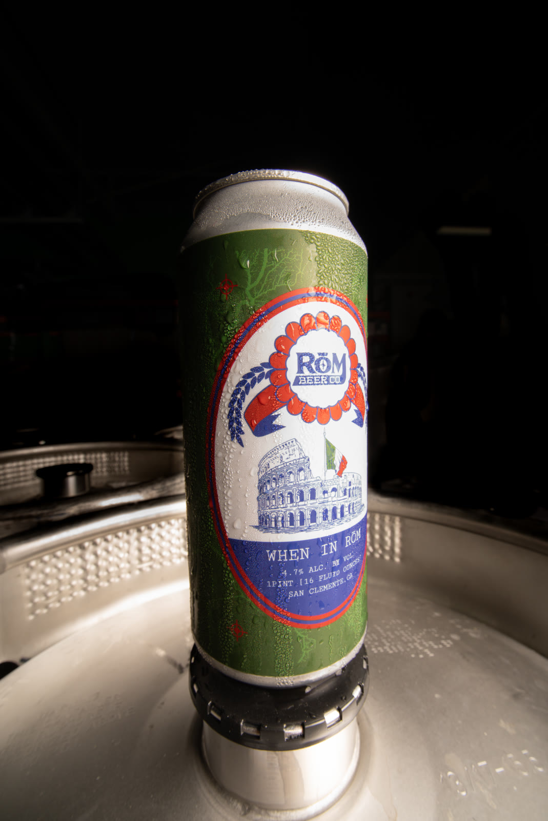 A RŌM beer can photographed against a dark background.